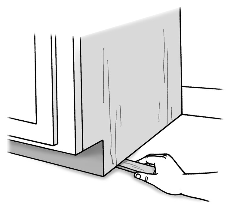 Figure 8-10: Wood shims level the cabinet.